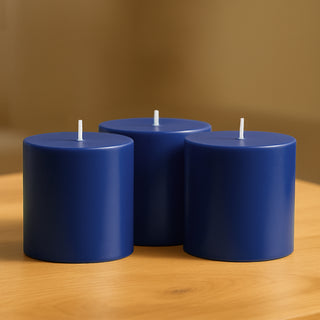 Blue cylindrical candles grouped on a wooden table.