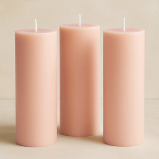 Pink pillar candles in varying heights.