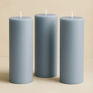 Three blue pillar candles in varying heights.