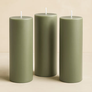 Three olive green pillar candles in varying heights.