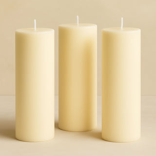 Set of three ivory pillar candles in varying heights.