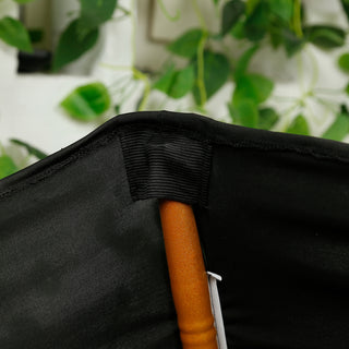 Close-up of the inner fabric and handle of a black umbrella.