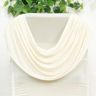 Cream draped fabric with soft folds on a white backdrop