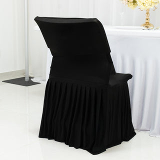 Black chair cover with pleated design for elegant event decor.