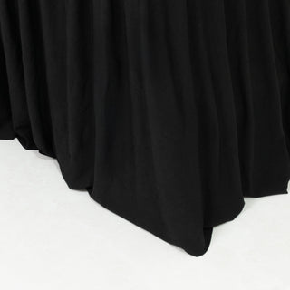 Black fabric draped elegantly, showcasing soft texture and flow.