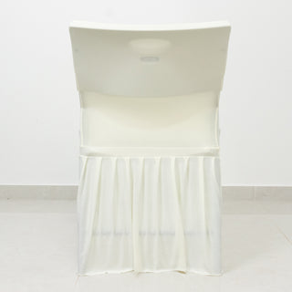 White folding chair with a draped skirt, shown against a plain backdrop.
