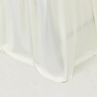 White satin tablecloth draping elegantly from a table edge