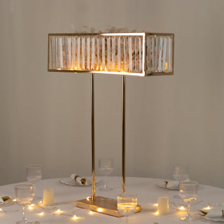 Elegant gold table lamp with decorative shade and soft glowing light.
