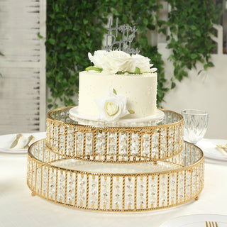 Elegant gold cake stand with mirrored surface and crystal accents, featuring a birthday cake.