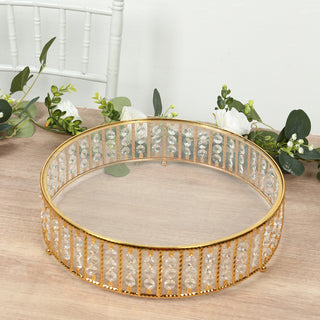 Elegant round crystal display tray with gold accents. Perfect for decor or serving.