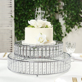 Elegant two-tier cake stand with floral decoration and "Happy Birthday" topper.