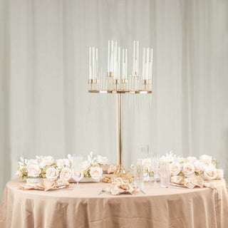 Elegant table centerpiece with candles and roses on a soft beige tablecloth.