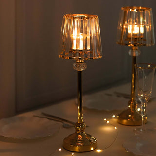 Elegant table lamp with golden base and crystal accents, softly glowing.