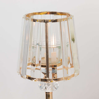 Elegant crystal lamp with gold accents and a clear shade.