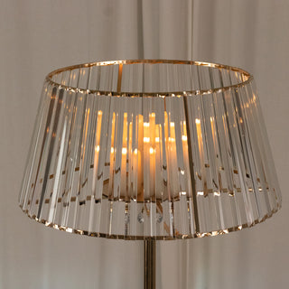 Elegant crystal lamp shade with warm candlelight glow.