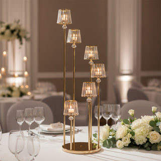 Elegant gold candle holder with glass shades, perfect for weddings and events.