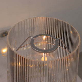 Modern glass candle holder with a sleek design and ribbed texture.