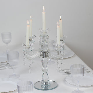 Elegant crystal candelabra with five candles on a dining table.
