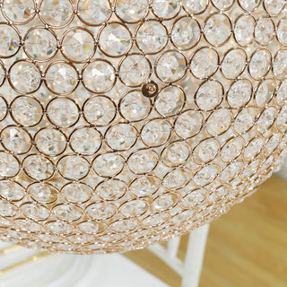 Elegant crystal chandelier with gold accents and intricate detailing.