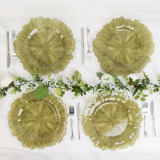 Green decorative plates arranged with utensils and greenery on a marble surface.