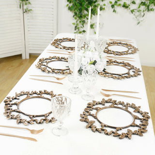 Elegant gold leaf placemats on a beautifully set dining table.