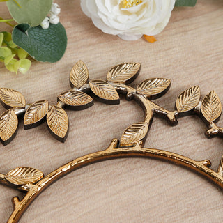 Gold leaf decorative frame with intricate detailing against a wooden background.