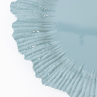 Blue decorative plate with a wavy edge design.