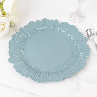 Blue decorative plate with a textured edge on a marble surface.