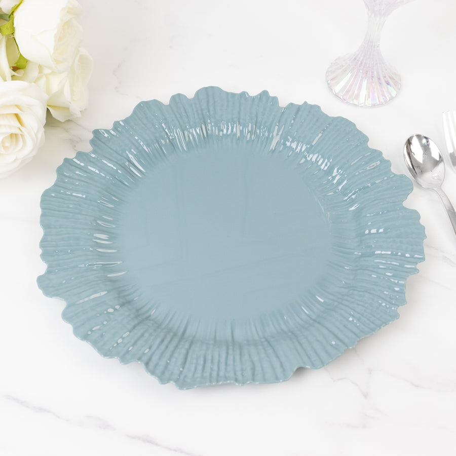 Blue decorative plate with a textured edge on a marble surface.