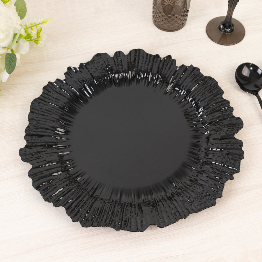 Black decorative plate with a ruffled edge on a light wooden surface.