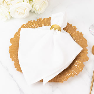 Elegant white napkin on a gold decorative plate with a napkin ring.