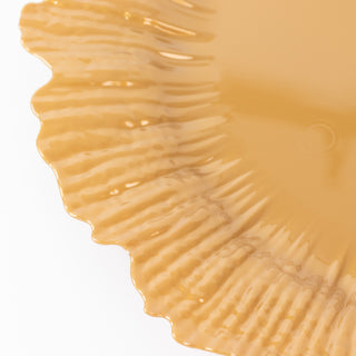 Textured yellow decorative plate with a scalloped edge.
