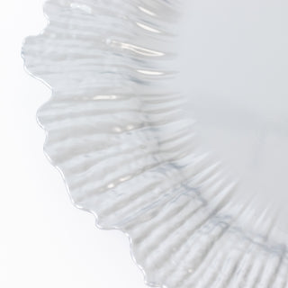 Clear decorative plate with a textured edge design.