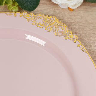 Elegant pink plate with intricate gold detailing on the rim.