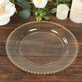 Clear glass plate with gold beaded edging on a wooden table.