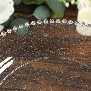 Clear decorative plate with beaded edge and glittery design.