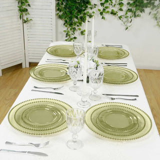 Elegant green glass dinnerware set on a beautifully arranged dining table.