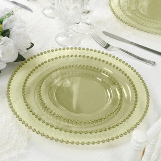 Green glass dinner plates stacked elegantly on a table setting.