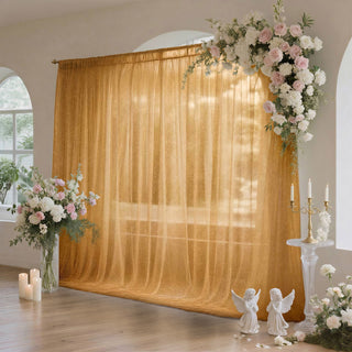 Elegant wedding floral arch with golden draped backdrop and candles