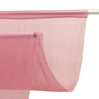 Pink sheer curtain panel hanging on a rod, close-up view