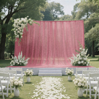 Pink outdoor wedding ceremony backdrop with white floral arrangements and chairs
