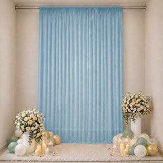 Elegant pastel balloon and floral backdrop with blue curtain for celebration décor