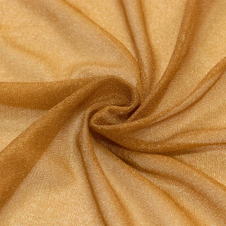 Golden shimmer fabric texture with elegant folded swirl pattern#whtbkgd
