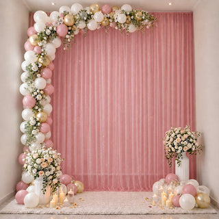 Pink and gold balloon arch with floral wedding or baby shower backdrop