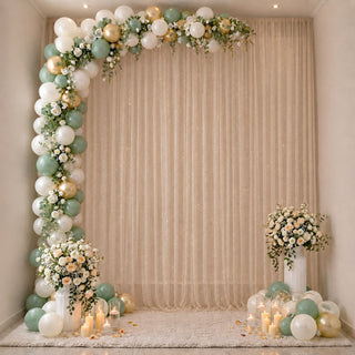 Elegant balloon and floral photo backdrop with candles and pastel decor
