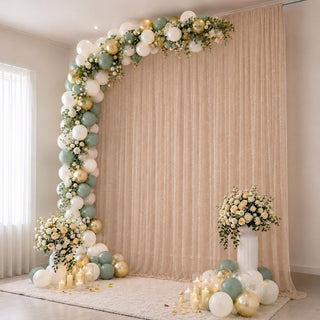 Elegant pastel balloon and floral party backdrop with candles and curtains