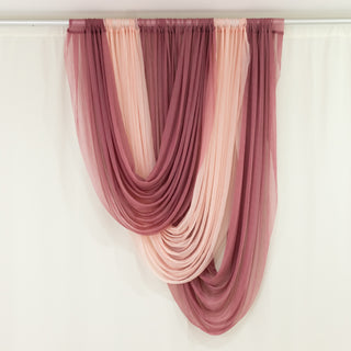 Draped fabric in burgundy and blush shades on a white backdrop