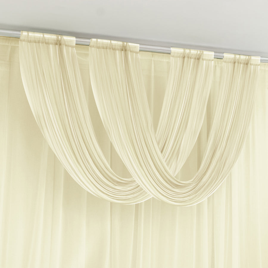 Sheer cream curtain drapes elegantly gathered at the top.