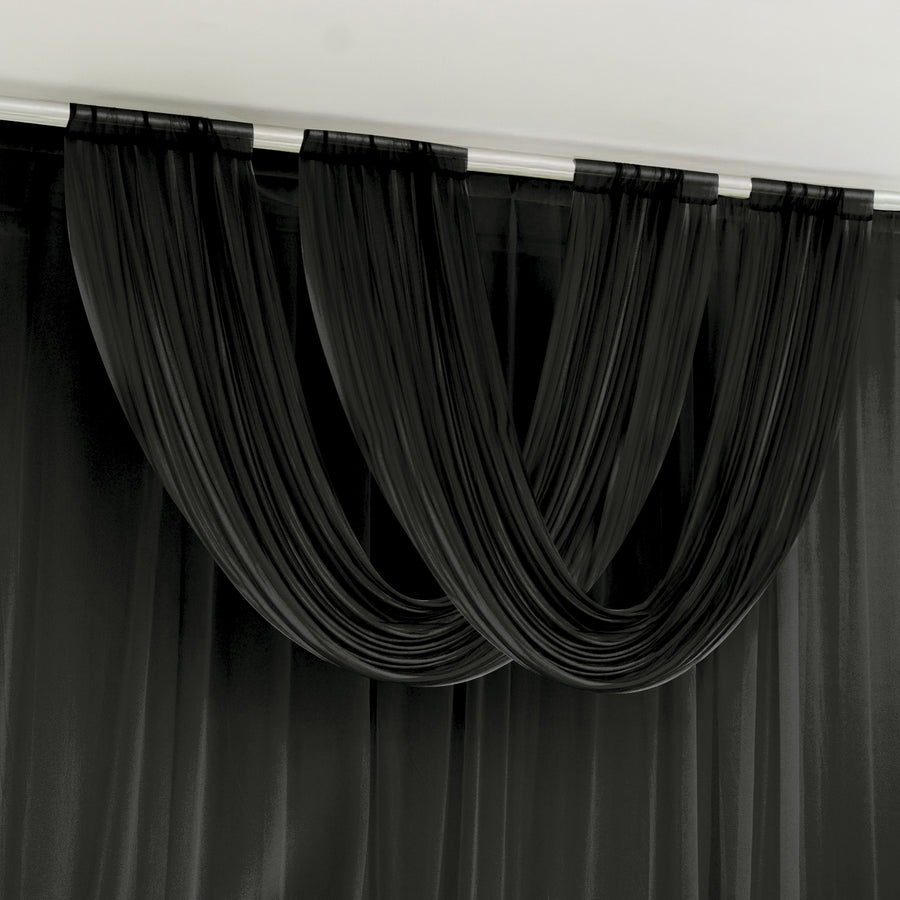 Black draped curtains in a modern interior setting.