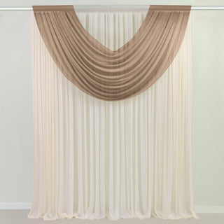 Draped fabric curtain in beige and cream colors for elegant decor.